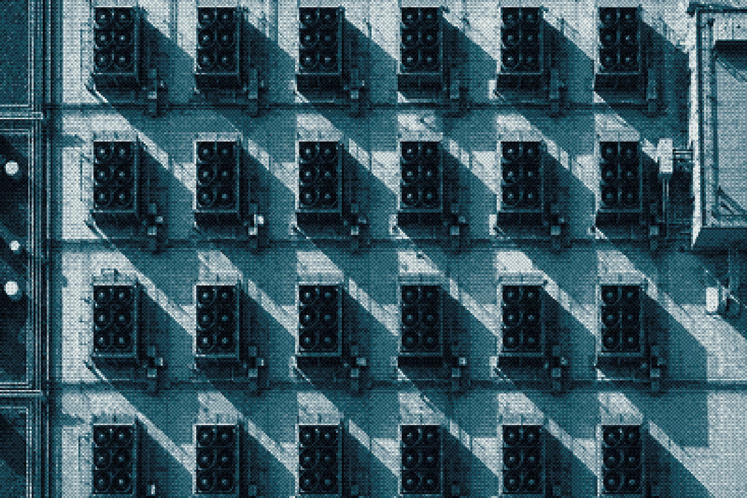 Overhead view of an engineering team working at a shared desk.